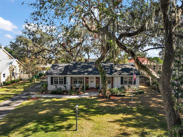 Ranch style home with mature trees and a large front yard at 734 Boylston St, Leesburg, FL 34748