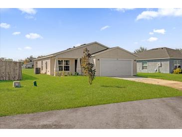 Newly constructed home with a one-car garage and a well-maintained lawn at Tbd S Central Ave # Parcel A, Apopka, FL 32703