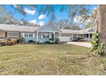 House exterior showing front yard landscaping and a partial view of neighboring homes at 8850 Sw 97Th St # E, Ocala, FL 34481
