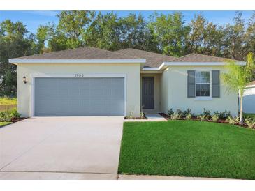 Charming one-story home boasts a two-car garage and well-manicured lawn, creating an inviting curb appeal at 2992 Supermarine Rd, Tavares, FL 32778