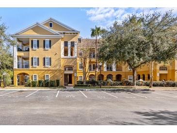 Inviting yellow condo building with ample parking at 3615 Conroy Rd # 614, Orlando, FL 32839