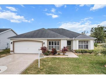 Attractive single-story home with a two-car garage and well-manicured lawn at 603 San Pedro Dr, Lady Lake, FL 32159