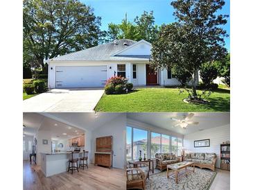 Charming single-story home featuring a well-manicured lawn, two-car garage, and lovely curb appeal at 17242 Se 94Th Coults Cir, The Villages, FL 32162