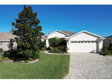 Landscaped one story home with two-car garage at 27103 Camerons Run, Leesburg, FL 34748