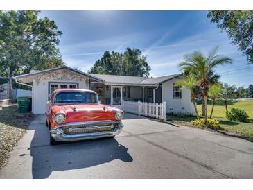 Ranch home with classic car in the driveway at 422 W 11Th Ave, Mount Dora, FL 32757