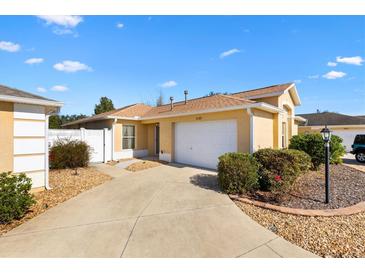 Charming one-story home with a two car garage and well-maintained landscaping at 2169 Smoaks St, The Villages, FL 32162