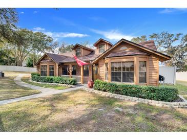 Two-story home with brick and wood siding at 18033 Rose St, Groveland, FL 34736