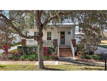 Charming farmhouse exterior with brick accents and a welcoming front porch at 2746 Se 19Th Ct, Ocala, FL 34471