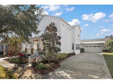 Stunning exterior of a two story home, featuring a well-manicured lawn, white siding and a long driveway at 2746 Se 19Th Ct, Ocala, FL 34471