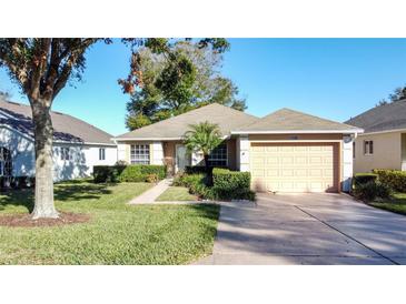 Cute one-story house with a two-car garage and well-manicured lawn at 3610 Rollingbrook St, Clermont, FL 34711