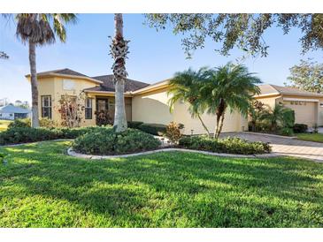 Single-story home with attractive landscaping and a paved driveway at 233 Monterey St, Kissimmee, FL 34759