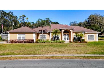 Beautiful one-story home with a large yard and mature trees at 305 W Lady Lake Blvd, Lady Lake, FL 32159