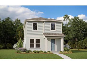 Two-story light green house with a teal door, small walkway, and landscaping at 16914 Hamlin Oasis Loop, Winter Garden, FL 34787