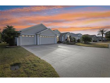 Luxury home with large driveway and surrounding community at 2054 Vision Ct, The Villages, FL 32163