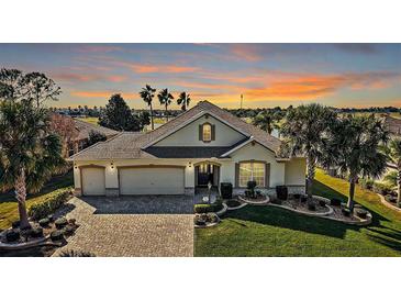 Beautiful one-story home with a large driveway and landscaped yard at 2202 Blackville Dr, The Villages, FL 32162