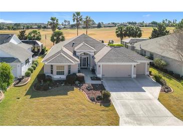 Beautiful home with golf course views, two-car garage, and landscaped yard at 276 Lawthorn St, The Villages, FL 32162