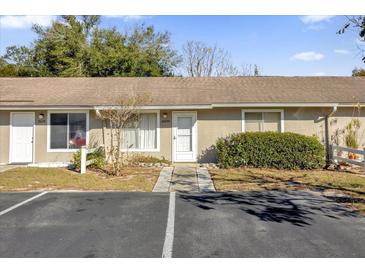 Front view of charming condo with parking and well-maintained landscaping at 30036 Tavares Ridge Blvd # 30036, Tavares, FL 32778