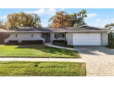 Updated single story home with a landscaped lawn and attached garage at 3336 Florene Dr, Orlando, FL 32806