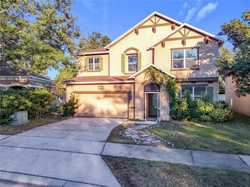 Two-story house with a large driveway and landscaped yard at 5036 Gandross Ln, Mount Dora, FL 32757