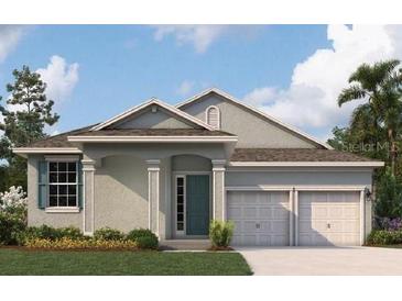 Two-story house with a two-car garage and landscaping at 5095 Firebush Dr, Apopka, FL 32712