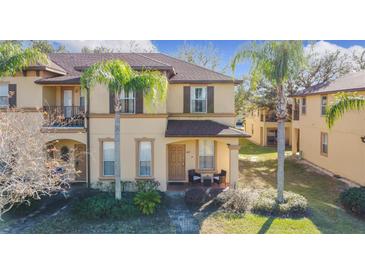 Two-story townhome with front porch and landscaping at 647 Calabria Ave, Davenport, FL 33897