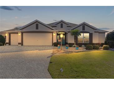 Attractive one-story home with a three-car garage and landscaped lawn at 1918 Yankee Clipper Run, The Villages, FL 32162