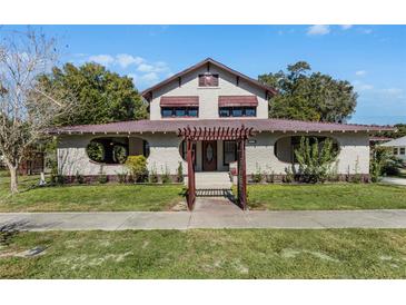 Charming two-story home with a red tile roof and manicured lawn at 211 Cassady St, Umatilla, FL 32784