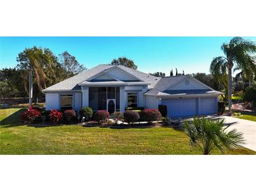 Beautiful single-story home with well-maintained landscaping, a two-car garage and a screened in porch at 24308 Belle Mede Dr, Leesburg, FL 34748