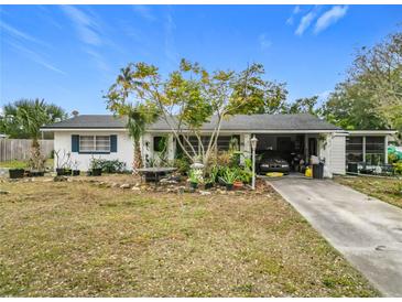 Ranch-style home with carport and mature landscaping at 3566 Seminole St, Gotha, FL 34734