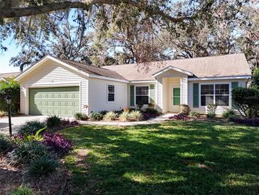 One-story house with green accents and mature landscaping at 3716 Plantation Blvd, Leesburg, FL 34748