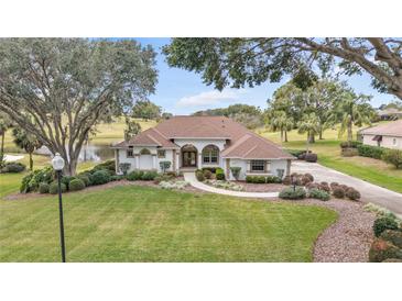 Single-story home with a tile roof and landscaped yard at 39335 Harbor Hills Blvd, Lady Lake, FL 32159