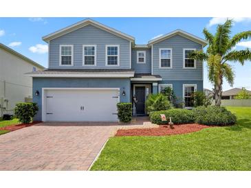 Two-story house with gray siding, white trim, and a two-car garage at 810 Maplebrook Loop, Apopka, FL 32703