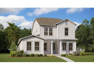 Two-story home with white siding, gray roof, and a landscaped lawn at 10049 Ballast Dr, Orlando, FL 32827