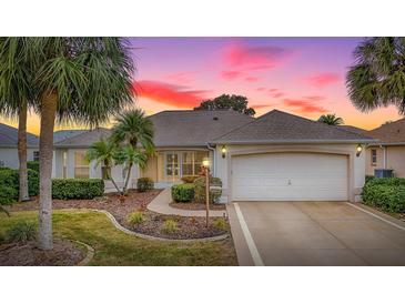 Inviting one-story home with landscaped yard and two-car garage at 1218 Augustine Dr, The Villages, FL 32159