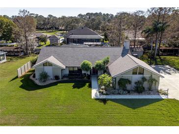 Single-Gathering home with a large backyard and pool, seen from above at 12430 Blue Heron Way, Leesburg, FL 34788