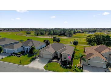 Aerial view of a house on a golf course community at 12592 Se 97Th Terrace Rd, Summerfield, FL 34491