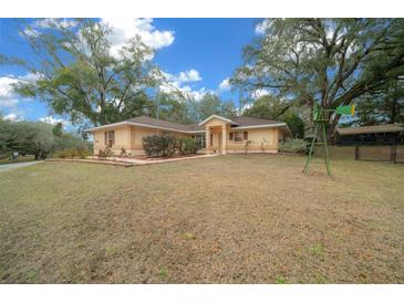 Single-story home with a spacious yard and mature trees at 13588 Sw 105Th Pl, Dunnellon, FL 34432