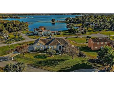 Luxury home on lakefront lot with expansive water views and lush landscaping at 17640 Las Brisas Ct, Winter Garden, FL 34787