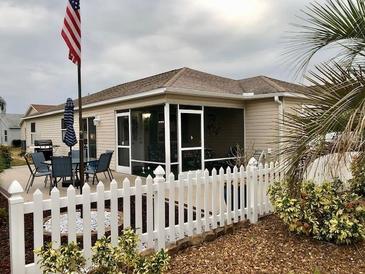 Charming home with fenced backyard, patio furniture, and screened-in porch at 2552 Mariel Way, The Villages, FL 32162