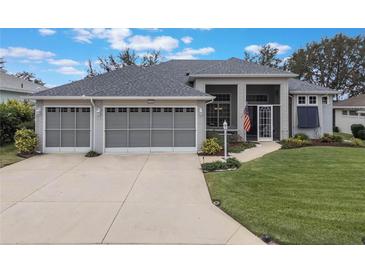 Attractive one-story home with a three-car garage and well-manicured lawn at 4928 Kelso St, Leesburg, FL 34748