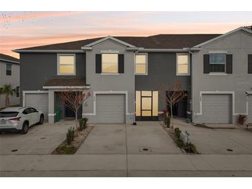 Modern two-story townhome with attached garage and landscaped front yard at 5278 Dragonfly Dr, Wildwood, FL 34785