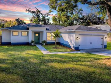 Newly built home with a green door and attached garage at 808 E Orange St, Apopka, FL 32703