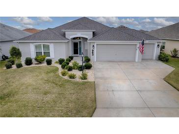 Attractive one-story home with a two-car garage and landscaped yard at 963 Hart Dr, The Villages, FL 32163