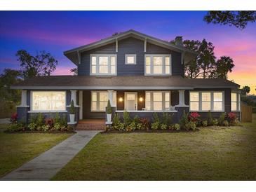 Charming two-story home with a renovated front porch and landscaped yard at 2001 Sanford Ave, Sanford, FL 32771