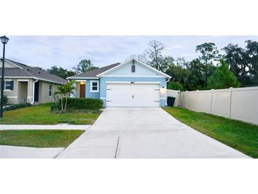 Cute blue house with a two-car garage and a landscaped front yard at 2295 Delhi Pl, Sanford, FL 32771