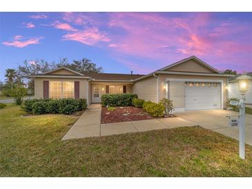 Attractive single-story home with landscaped yard and two-car garage at 3200 Woodridge Dr, The Villages, FL 32162