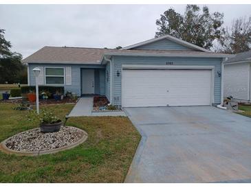 Cute Florida home with attached garage and landscaped yard at 32218 Sweet Briar Court, Leesburg, FL 34748