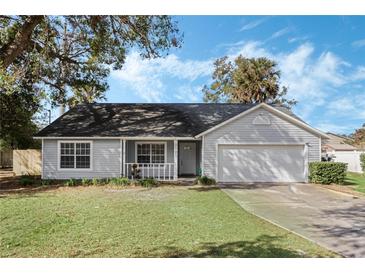 Gray house with a two-car garage and a well-maintained lawn at 2121 Croat St, Mount Dora, FL 32757