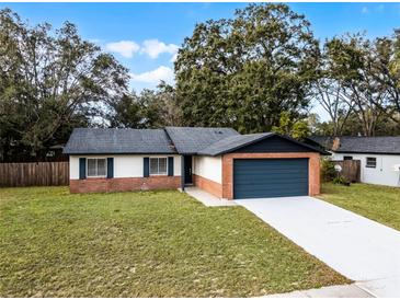 Updated single story home with a new garage door and landscaping at 2725 Lakewood Ln, Eustis, FL 32726