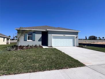 Charming single-Gathering home featuring a well-manicured lawn and a two-car garage at 2848 Supermarine Rd, Tavares, FL 32778